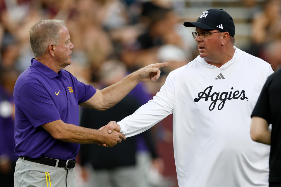 COLLEGE STATION, TEXAS - OCTOBER 26: Head coach Brian Kelly of the LSU Tigers greets head coach Mike Elko of the Texas A&M Aggies before the game at Kyle Field on October 26, 2024 in College Station, Texas. (Photo by Tim Warner/Getty Images)