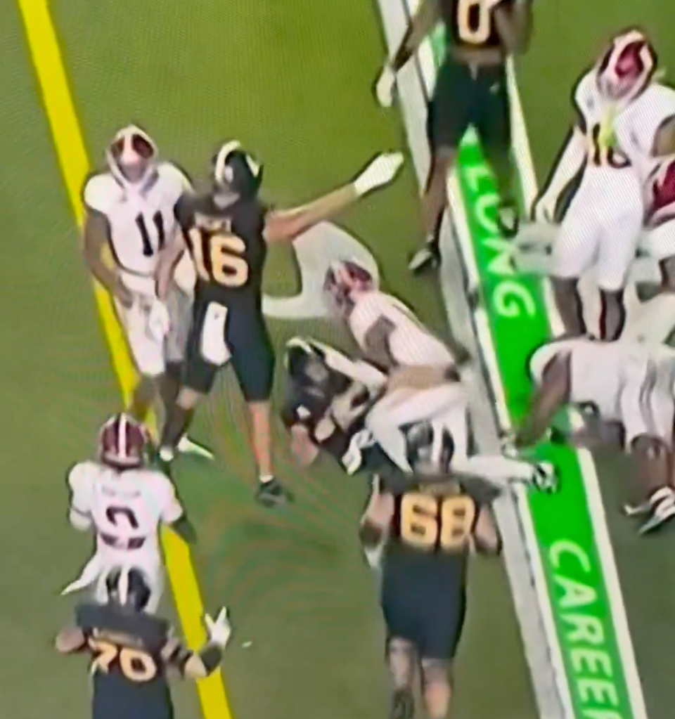 Alabama's Malachi Moore slams a Vanderbilt player's head into the ground after a tackle on the final play.