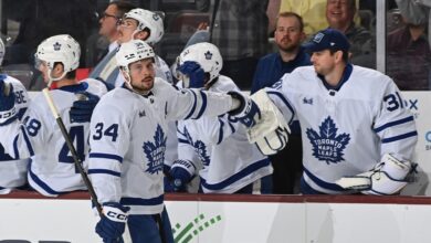 Auston Matthews celebrates with teammates after scoring his 50th goal during the Maple Leafs' win.