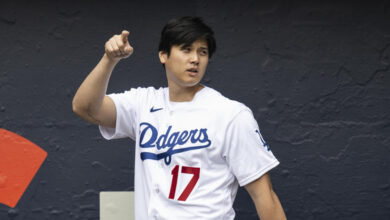 Los Angeles Dodgers' Shohei Ohtani walks to the stage during the team's fan fest in Los Angeles, Saturday, Feb. 3, 2024. (AP Photo/Kyusung Gong)