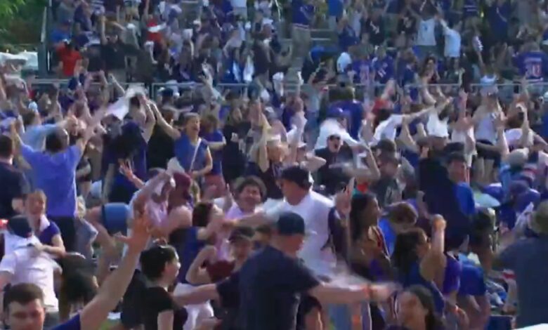 Rangers fans celebrate the overtime goal Sunday while in Central Park.