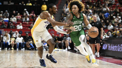 LAS VEGAS, NEVADA - JULY 15: JD Davison #20 of the Boston Celtics drives past Bronny James Jr. #9 of the Los Angeles Lakers in the first half of a NBA Summer League game at the Thomas & Mack Center on July 15, 2024 in Las Vegas, Nevada. NOTE TO USER: User expressly acknowledges and agrees that, by downloading and or using this photograph, User is consenting to the terms and conditions of the Getty Images License Agreement. (Photo by Candice Ward/Getty Images)