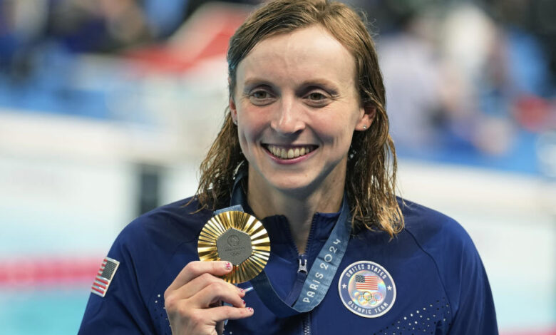 United States' Katie Ledecky celebrates with the gold medal during the awards ceremony for the women's 800-meter freestyle at the Summer Olympics in Nanterre, France, Saturday, Aug. 3, 2024. (AP Photo/Brynn Anderson)