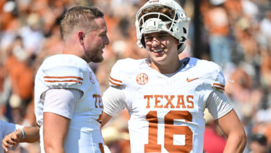 DALLAS, TEXAS - OCTOBER 12: Arch Manning #16 and Quinn Ewers #3 of the Texas Longhorns talk on the field before a game O at Cotton Bowl Stadium on October 12, 2024 in Dallas, Texas. (Photo by Sam Hodde/Getty Images)