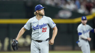 Los Angeles Dodgers pitcher Clayton Kershaw watches the flight of a fly ball during the first inning of a baseball game against the Arizona Diamondbacks Friday, Aug. 30, 2024, in Phoenix. (AP Photo/Ross D. Franklin)