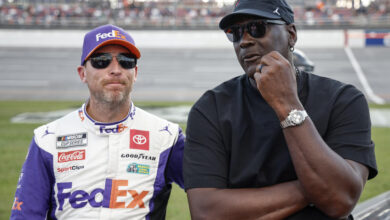 TALLADEGA, ALABAMA - OCTOBER 06: Co-owners of 23XI Racing, Denny Hamlin, driver of the #11 FedEx One Rate Toyota, and NBA Hall of Famer, Michael Jordan talk on the grid after the NASCAR Cup Series YellaWood 500 at Talladega Superspeedway on October 06, 2024 in Talladega, Alabama. (Photo by Chris Graythen/Getty Images)