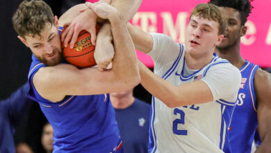 LAS VEGAS, NEVADA - NOVEMBER 26: Hunter Dickinson #1 of the Kansas Jayhawks ties up Cooper Flagg #2 of the Duke Blue Devils for a jump ball in the first half of a game during the Vegas Showdown at T-Mobile Arena on November 26, 2024 in Las Vegas, Nevada. (Photo by Ethan Miller/Getty Images)