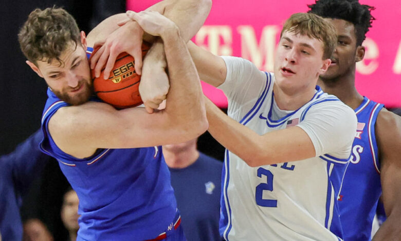 LAS VEGAS, NEVADA - NOVEMBER 26: Hunter Dickinson #1 of the Kansas Jayhawks ties up Cooper Flagg #2 of the Duke Blue Devils for a jump ball in the first half of a game during the Vegas Showdown at T-Mobile Arena on November 26, 2024 in Las Vegas, Nevada. (Photo by Ethan Miller/Getty Images)