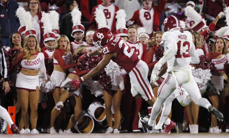 NORMAN, OKLAHOMA - NOVEMBER 23:  Running back Xavier Robinson #21 of the Oklahoma Sooners dives for the end zone to score an 18-yard touchdown against the Alabama Crimson Tide in the second quarter at Gaylord Family Oklahoma Memorial Stadium on November 23, 2024 in Norman, Oklahoma.  (Photo by Brian Bahr/Getty Images)