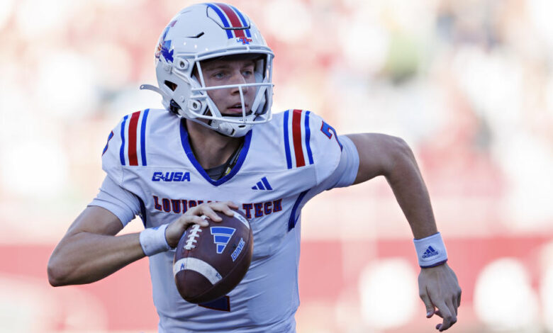 FAYETTEVILLE, ARKANSAS - NOVEMBER 23: Evan Bullock #7 of the Louisiana Tech Bulldogs rolls out to pass during a game against the Arkansas Razorbacks at Donald W. Reynolds Razorback Stadium on November 23, 2024 in Fayetteville, Arkansas. The Razorbacks defeated the Bulldogs 35-14.  (Photo by Wesley Hitt/Getty Images)