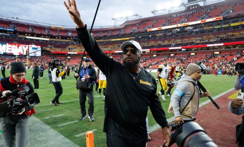 Pittsburgh Steelers head coach Mike Tomlin celebrates while leaving the field after the Steelers' game against the Washington Commanders at Northwest Stadium.